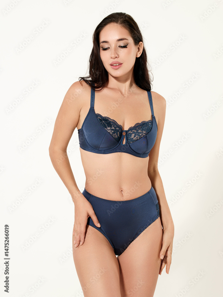 Fototapeta premium Sexy girl model in a beautiful swimsuit, fashion shooting in the studio.