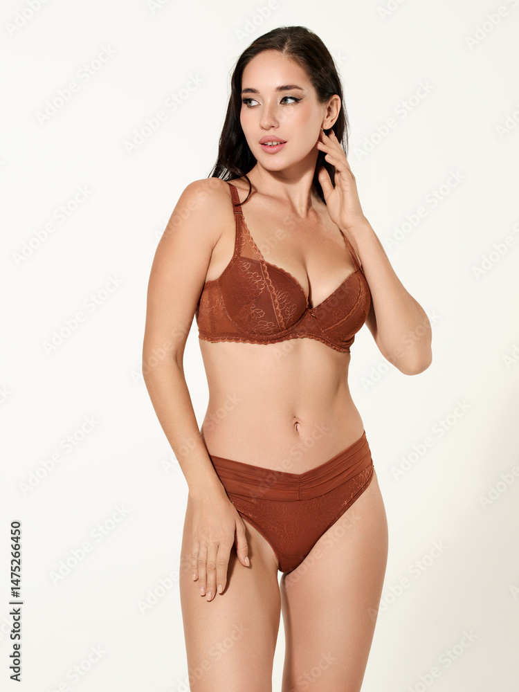 Fototapeta premium Sexy girl model in a beautiful swimsuit, fashion shooting in the studio.