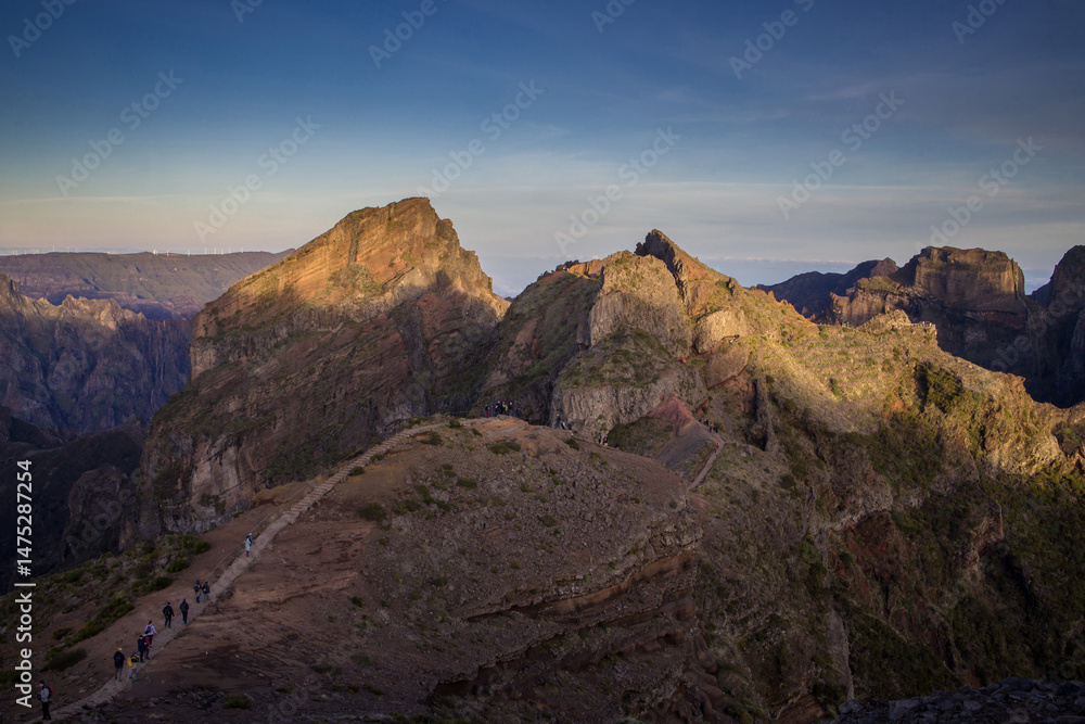 Fototapeta premium Exploring Pico do Arieiro in Madeira during early morning light with hiking trails and stunning mountain views