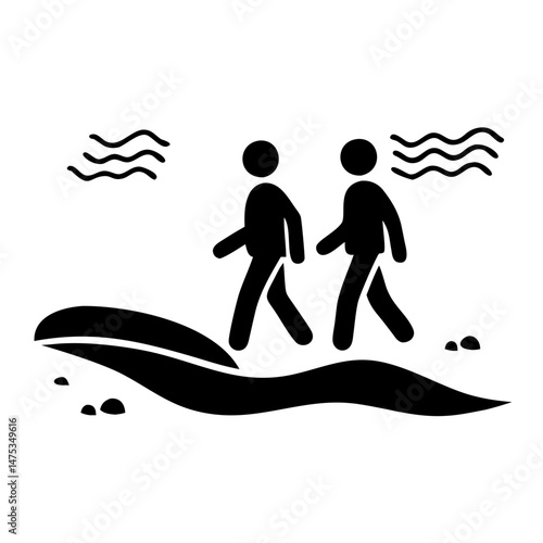 Two people walking on the beach with the waves crashing nearby