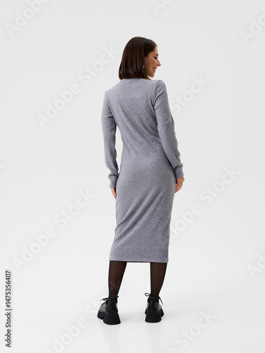 Pregnant girl model in stylish clothes on white background in studio.