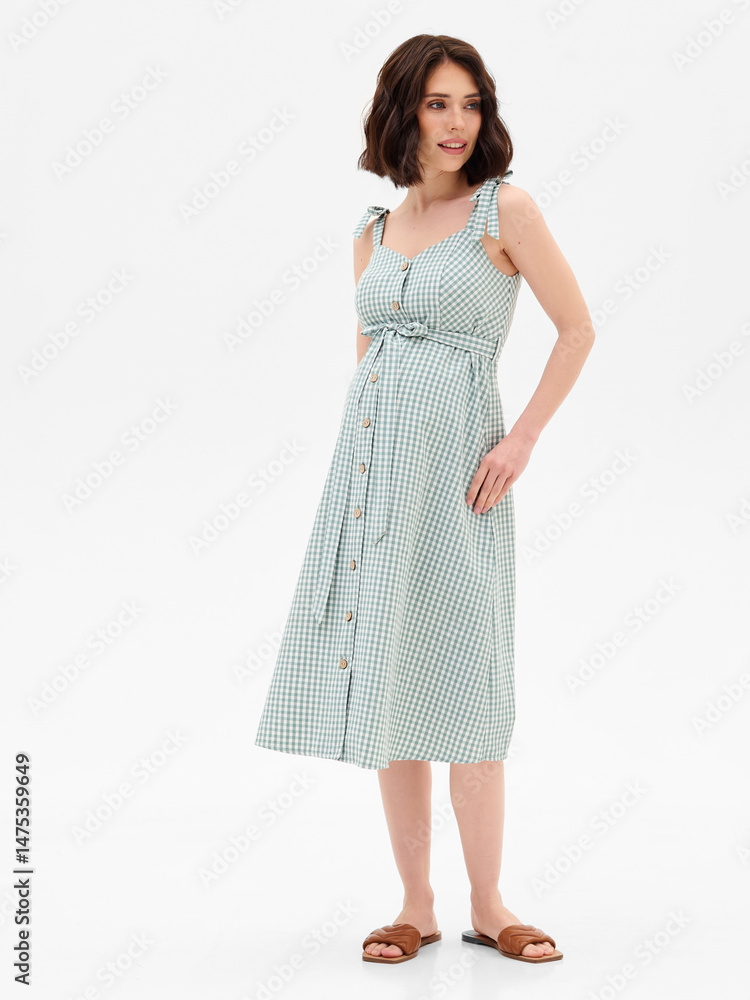 Naklejka premium Pregnant girl model in stylish clothes on white background in studio.