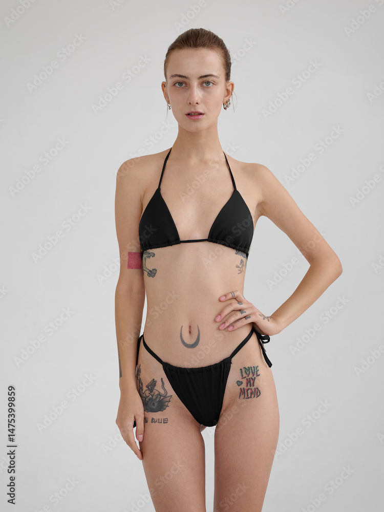 Girl model posing in studio on light background. Girl model posing in studio on light background.