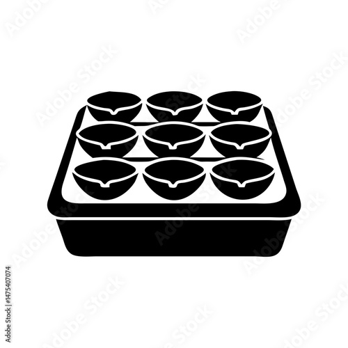 Black silhouette image of nine tart shells in a baking tray