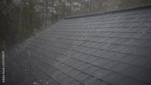 Hailstorm causing roof damage to house 