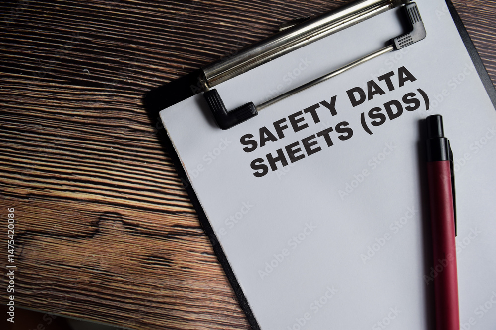 Concept of Safety Data Sheets - SDS write on paperwork isolated on Wooden Table. Concept of Safety Data Sheets - SDS write on paperwork isolated on Wooden Table.