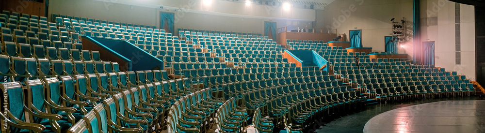 Fototapeta premium Empty Theater with Rows of Blue Seats and Stage