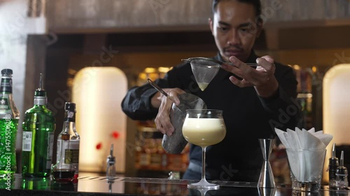 Wallpaper Mural Asian bartender using strainer all ingredients alcohol liquor and syrup tasty in cocktail glass with ice serving special refresh drink showcasing nightlife mixology at luxurious nightclub. Vinosity. Torontodigital.ca