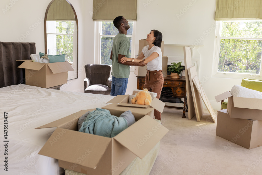 Couple unpacking boxes in new home, smiling and enjoying fresh start together Couple unpacking boxes in new home, smiling and enjoying fresh start together