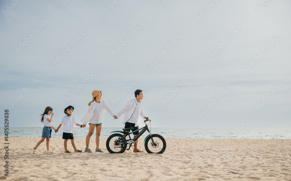 Obraz premium Parents and children walking on the sandy beach pushing bicycles a family scene filled with smiles happiness and the carefree enjoyment of a day under the sun. Family on beach vacation