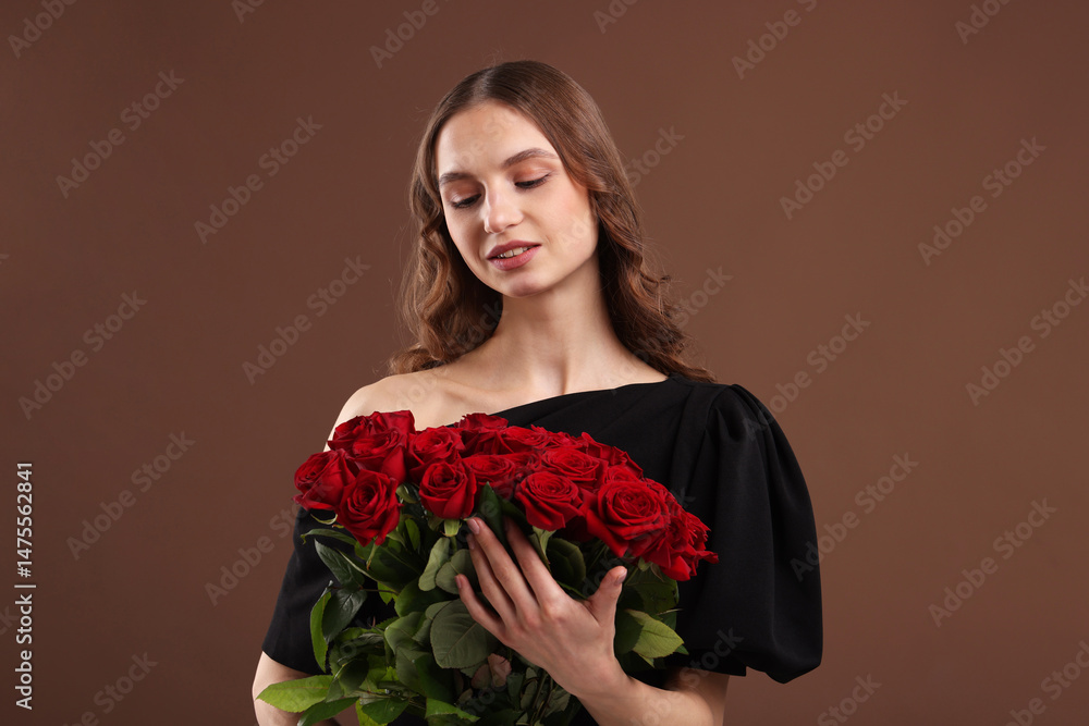 Smiling woman with bouquet of roses on brown background Smiling woman with bouquet of roses on brown background