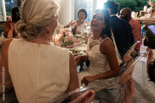 Canvas Print Bride laughing joyfully with guests at elegant wedding reception dinner