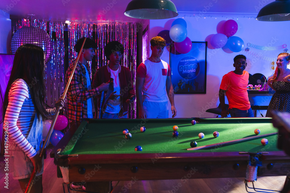 Fototapeta premium Teenagers playing pool at lively party, enjoying vibrant celebration with friends