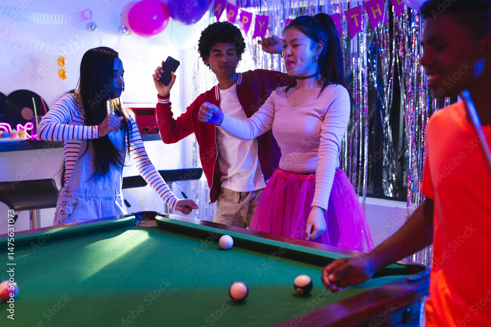 Fototapeta premium Teenagers celebrating at party, dancing and playing pool with joyful expressions
