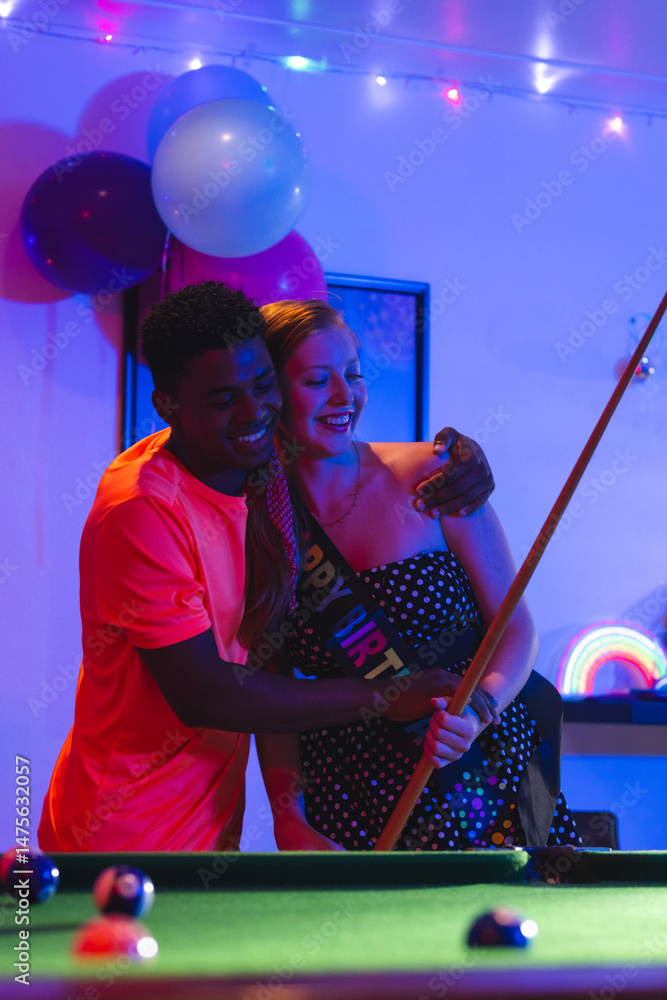 Fototapeta premium Teenagers celebrating birthday playing pool, smiling and enjoying party atmosphere