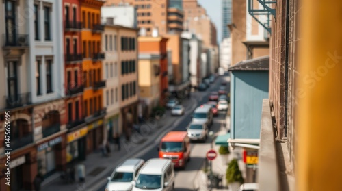 Busy urban street with colorful buildings and moving vehicles.