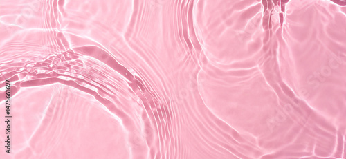 Crystal clear pink beach water with gentle ripples