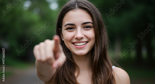 Wallpaper Mural Smiling Woman Points Directly at Viewer: A Cheerful, Close-Up Portrait Torontodigital.ca