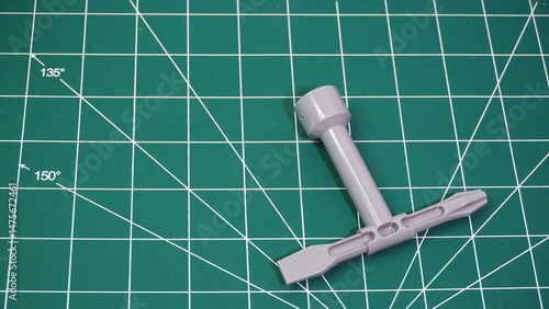 Green cutting mat with measurement grid lines, used for crafting, sewing, DIY projects, and precision cutting work.