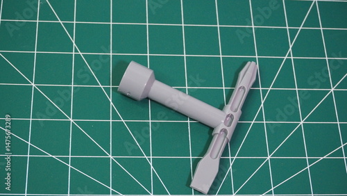 Green cutting mat with measurement grid lines, used for crafting, sewing, DIY projects, and precision cutting work.