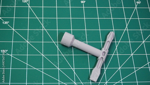 Green cutting mat with measurement grid lines, used for crafting, sewing, DIY projects, and precision cutting work.