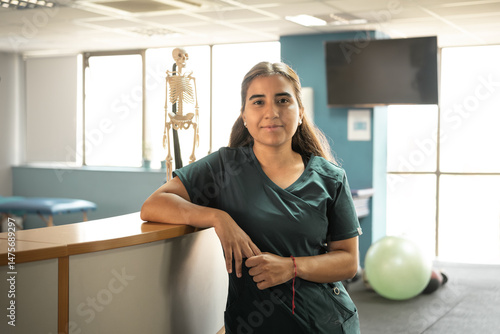 Portrait of female doctor in medical office with anatomical skeleton