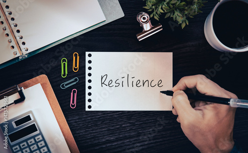 There is notebook with the word Resilience. It is as an eye-catching image.