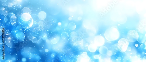 Abstract background of light blue bokeh patterns.