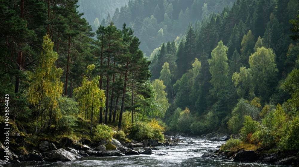 Obraz premium Serene River Flowing Through Lush Green Forest with Majestic Mountains in the Background Under Soft Overcast Sky