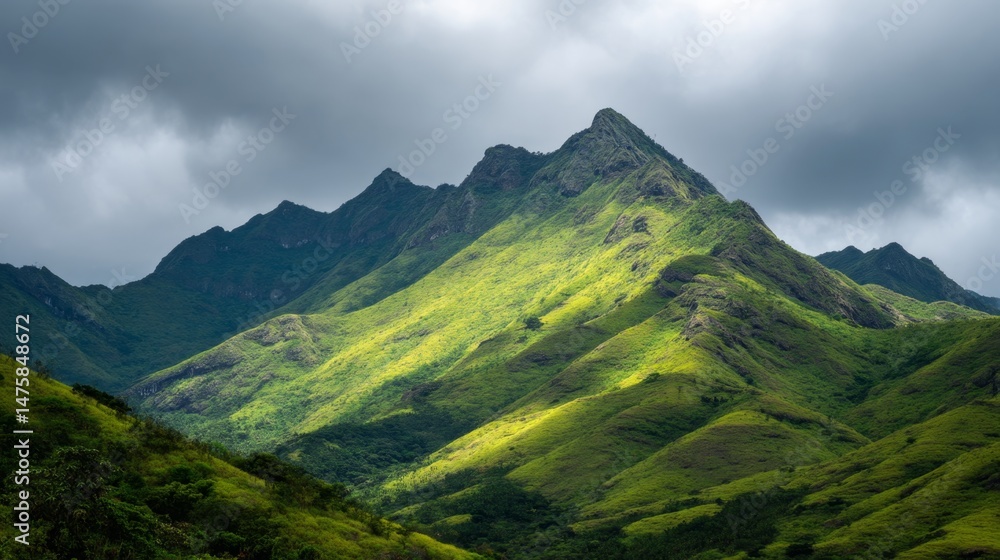 Fototapeta premium Majestic Green Mountain Landscape Under Dramatic Cloudy Sky