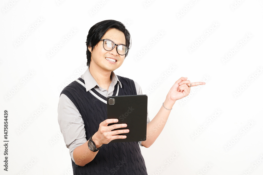 Smile Holding Tablet and Pointing Side Of Handsome Asian Man Isolated On White Background Smile Holding Tablet and Pointing Side Of Handsome Asian Man Isolated On White Background
