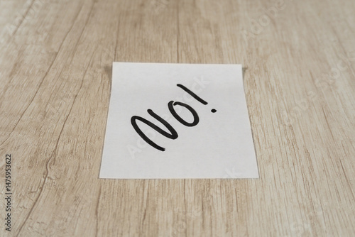 “No” written in black marker pen on a sticky note positioned in the center.
