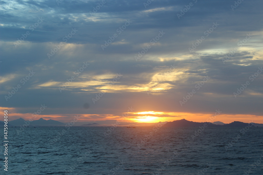 Fiery skies contrast against gentle waves, capturing an awe-inspiring moment for travel, nature, and lifestyle creatives. Fiery skies contrast against gentle waves, capturing an awe-inspiring moment for travel, nature, and lifestyle creatives.