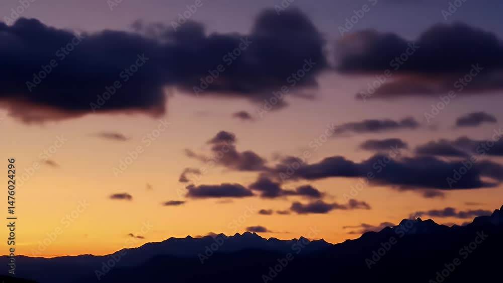 Vibrant Sunset Sky with Pink and Orange Clouds above Dark Mountain Silhouette Vibrant Sunset Sky with Pink and Orange Clouds above Dark Mountain Silhouette