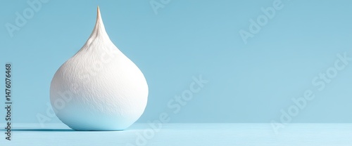 Minimalist image of a pear-shaped white form with a pointed top on a light blue background