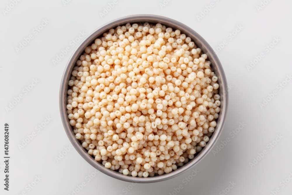 Overhead shot of cooked ptitim in gray bowl on white background Overhead shot of cooked ptitim in gray bowl on white background