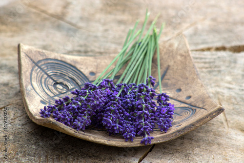 Bunch of lavender flowers on clay plate