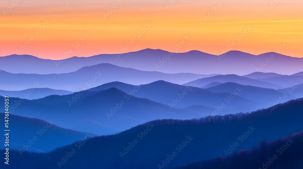 Fototapeta premium Colorful sunrise over a misty mountain range.