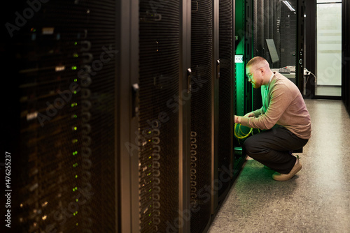 Obraz na płótnie Technician configuring server equipment in data center