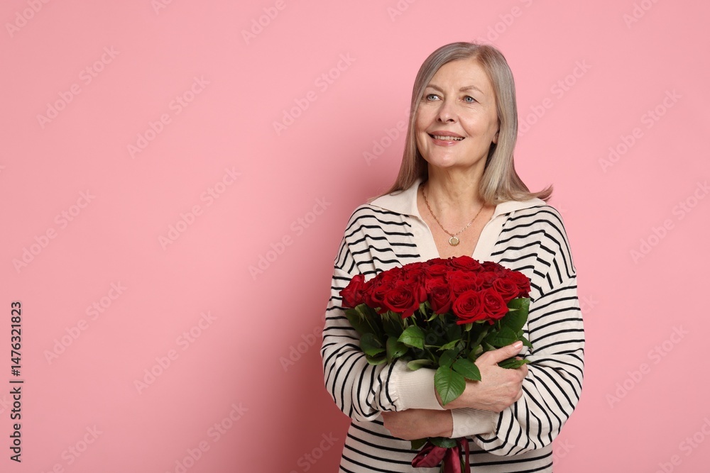 Smiling woman with bouquet of roses on pink background. Space for text Smiling woman with bouquet of roses on pink background. Space for text