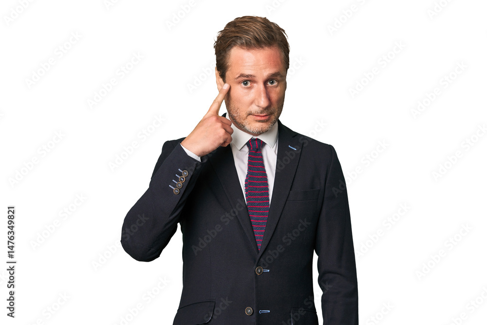 A middle-aged businessman isolated pointing temple with finger, thinking, focused on a task. A middle-aged businessman isolated pointing temple with finger, thinking, focused on a task.