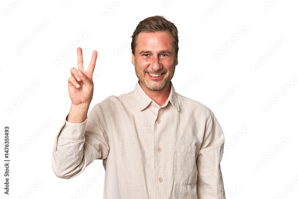 A middle-aged man isolated joyful and carefree showing a peace symbol with fingers. A middle-aged man isolated joyful and carefree showing a peace symbol with fingers.