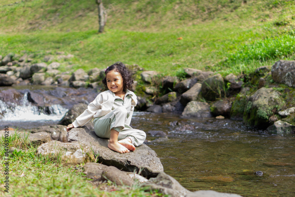 A curly haired daughter make vacation in a river with smilling face A curly haired daughter make vacation in a river with smilling face