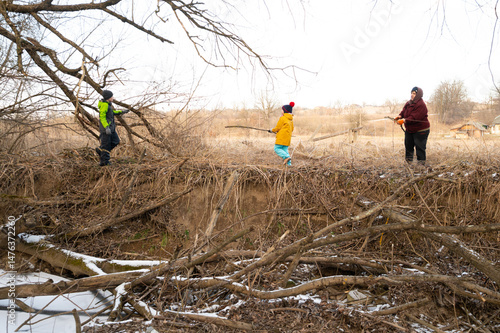 Wallpaper Mural Joyful moments of children playing along a riverbank in late winter, creating memories with sticks and laughter in a serene natural setting Torontodigital.ca