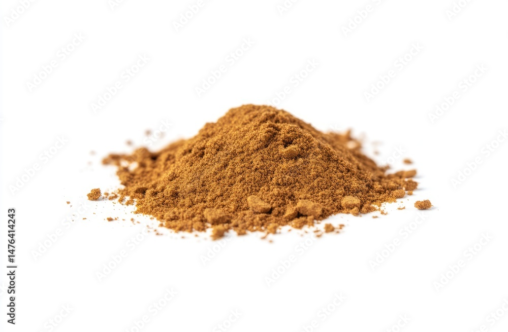 Pile of ground spice, light brown in color, sits atop a white background. The spice is a slightly uneven mound, with some fine particles dispersed around the base Pile of ground spice, light brown in color, sits atop a white background. The spice is a slightly uneven mound, with some fine particles dispersed around the base