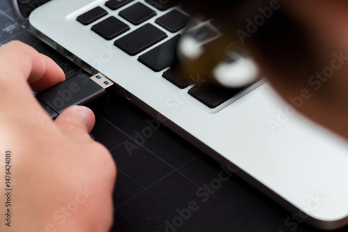 Vászonkép Hand inserting Flash drive memory drive plugged into a computer laptop port
