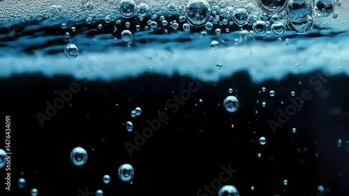 Pure Blue Water with Bubbles and Foam Against a Black Background