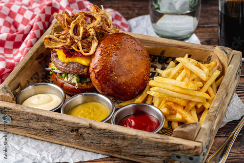 Bilde på lerret Gourmet beef burger with pastrami, cheddar, caramelized onions, and fries