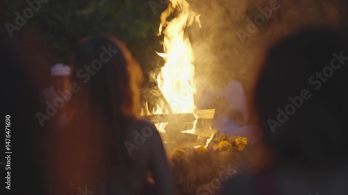 Sacred Fire Ritual with Silhouettes and Bonfire at Night