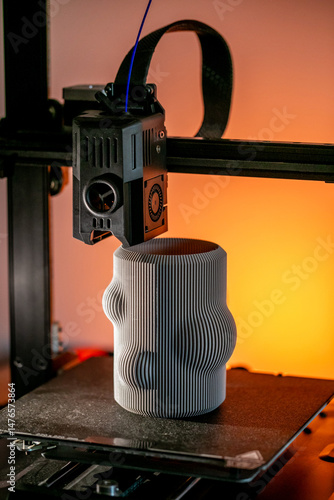 Intricately bizarre 3D-printed vase emerges from the machine glow, evoking Pi Day symmetry and World Creativity Week celebrations, 3D printer, 3D printing